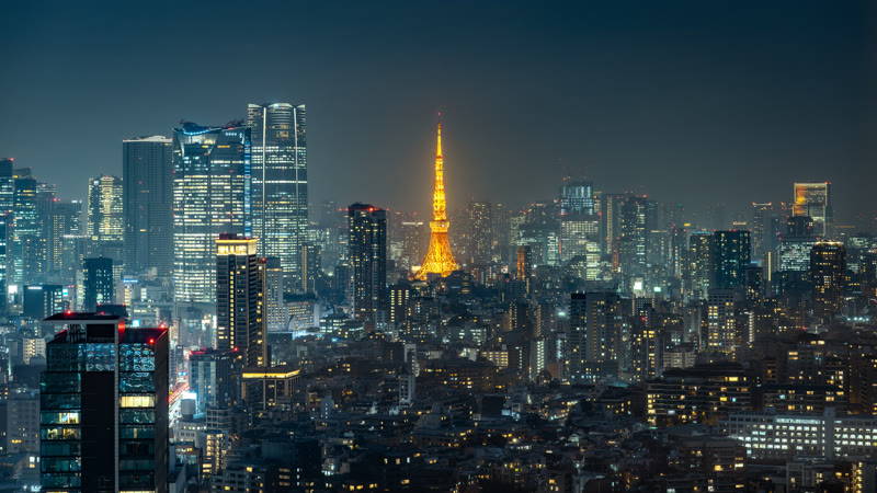 Tokyo Tower lit above the surrounding city at night